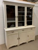 A painted oak dresser, with three glazed doors opening to shelves, the base has three drawers and