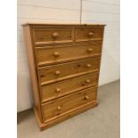 A pine chest of drawers, two short over four long (H118cm W90cm D43cm)