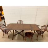 An Ercol elm dining table with extensions table/side table with four chairs (Main table 136cm x