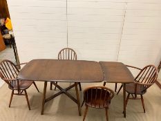 An Ercol elm dining table with extensions table/side table with four chairs (Main table 136cm x