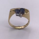 A 14ct gold ring with sapphires and diamond (4.6g) Size P