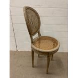 A French style bedroom chair with cane seta and back