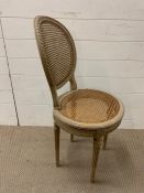 A French style bedroom chair with cane seta and back