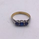An 18ct three stone ring Size K