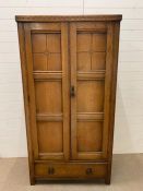 An Arts and Crafts Style Gentleman's wardrobe h 179 cm x W 95 cm x D 46 cm.