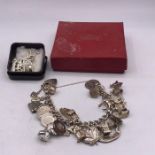 A Silver charm bracelet and some loose charms (93g)