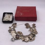 A Silver charm bracelet and some loose charms (93g)