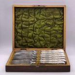 A Boxed set of six silver plated knives and forks