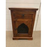 A hardwood bedside table with drawer and cupboard under with lattice door (H64cm W44cm D31cm)