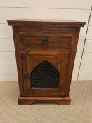 A hardwood bedside table with drawer and cupboard under with lattice door (H64cm W44cm D31cm)