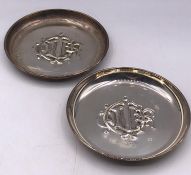 Two Christian Dior white metal coasters