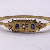 A Gold bangle, marked 15ct with diamonds and sapphires (8g)