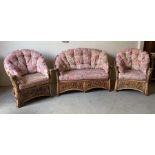 A cane conservatory suite comprising of a two seater sofa and two arm chairs (H90cm W140cm D 86cm