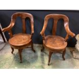 A pair of Italian barbers swivel chairs on four down swept legs and cross stretchers (H94cm W61cm)