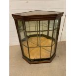 A Glass terrarium or display cabinet in a corner style.