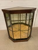 A Glass terrarium or display cabinet in a corner style.