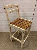 A tall kitchen chair with slatted seat