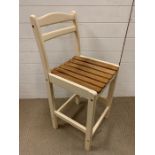 A tall kitchen chair with slatted seat