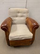 An armchair with leather arms and sides and oak back frame with separate upholstered cushions