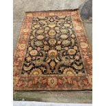 A very large floral rug with red boarder (394cm x 275cm)
