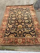 A very large floral rug with red boarder (394cm x 275cm)