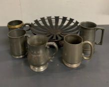 An metal and wooden bowl along with five metal jugs/cups