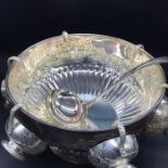 A Silverplated Punch Bowl with floral decoration.