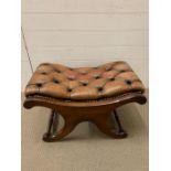 A mahogany leather upholstered foot stool with turned stretchers (H45cm W69cm D45cm)