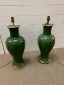 A pair of large emerald green crackle glaze table lamps of baluster form on gilt mounts and fitted