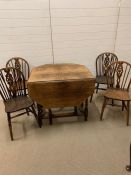 A gateleg dining table with barley twist legs and scalloped edge back chairs (120cm x 80cm)