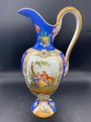 An "Old Paris" porcelain ewer, the body with panels depicting gallant scenes, a blue ground