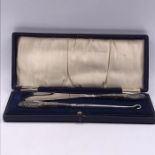 A Cased set of silver handled, hallmarked, button hook and shoehorn.