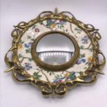 A Royal Staffordshire pottery plaque mounted in a brass decorative ring framing a convex mirror