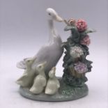 A Lladro figure of a goose with goslings.