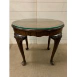 A mahogany oval side table on cabriole legs