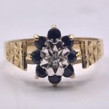 A 9ct gold ring with white and blue stones. Size N