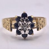 A 9ct gold ring with white and blue stones. Size N