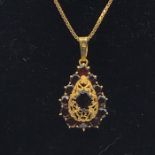 An 18ct gold necklace and pendant with garnets (7.7g)