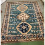 A blue rug with three circular patterns to centre (224cm x 176cm)