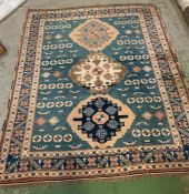 A blue rug with three circular patterns to centre (224cm x 176cm)