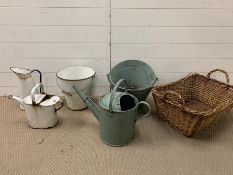 A selection of enamel and metal buckets and jugs, along with a wicker basket