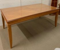 An eight seater dining table with glass top (H78cm W184cm D100cm)