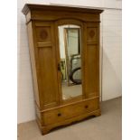 A wardrobe or coat cupboard with mirrored front panel door and drawer to base (H207cm W134cm D54cm)