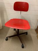 A vintage red swirl desk chair