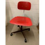 A vintage red swirl desk chair