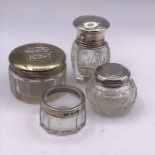 A Selection of four various silver topped jars, hallmarked.