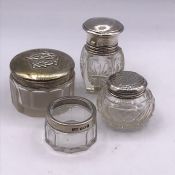 A Selection of four various silver topped jars, hallmarked.