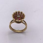 A Persian Gold Ring with diamond and five small rubies (5.2g) Size L