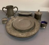 A selection of pewter to include charge plates, lidded pots and jug