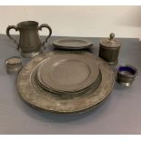 A selection of pewter to include charge plates, lidded pots and jug